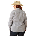 Woman wearing a patterned shirt, jeans, and a cowboy hat on a white background
