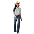 Woman wearing a patterned shirt, jeans, and a cowboy hat on a white background