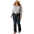 Woman wearing a patterned shirt, jeans, and a cowboy hat on a white background