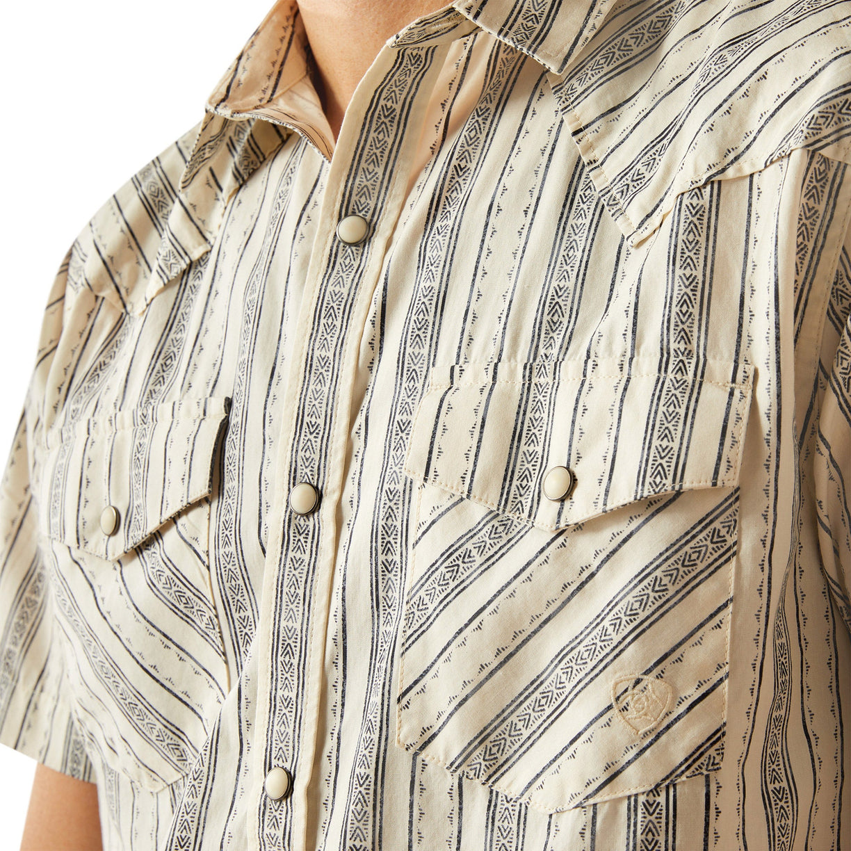 Close-up of a patterned shirt with vertical stripes and button details.