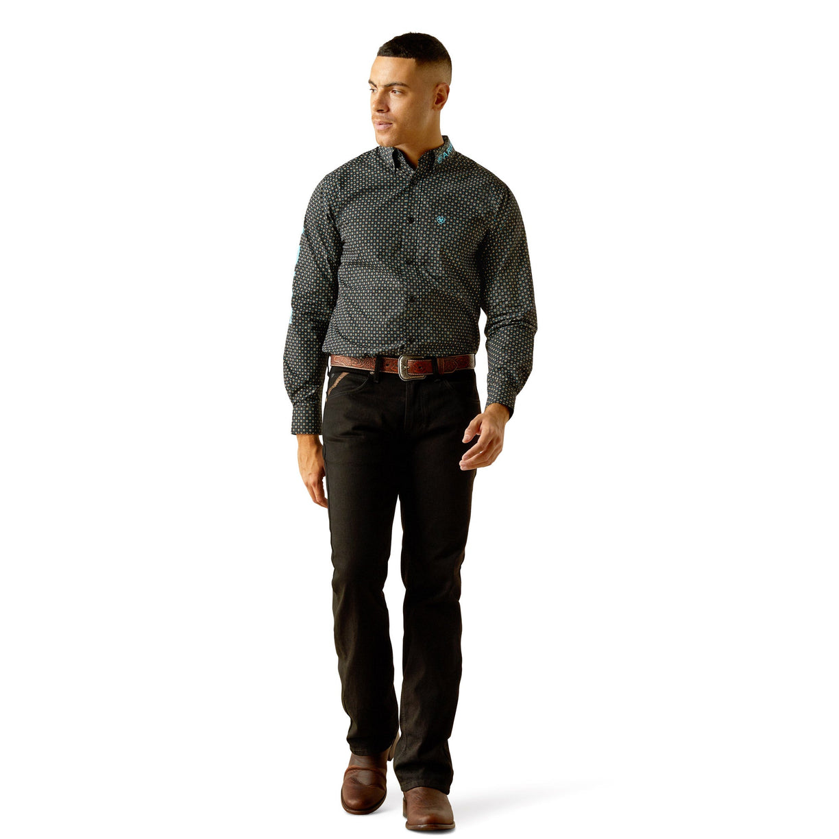Man wearing a patterned shirt and dark pants on a white background