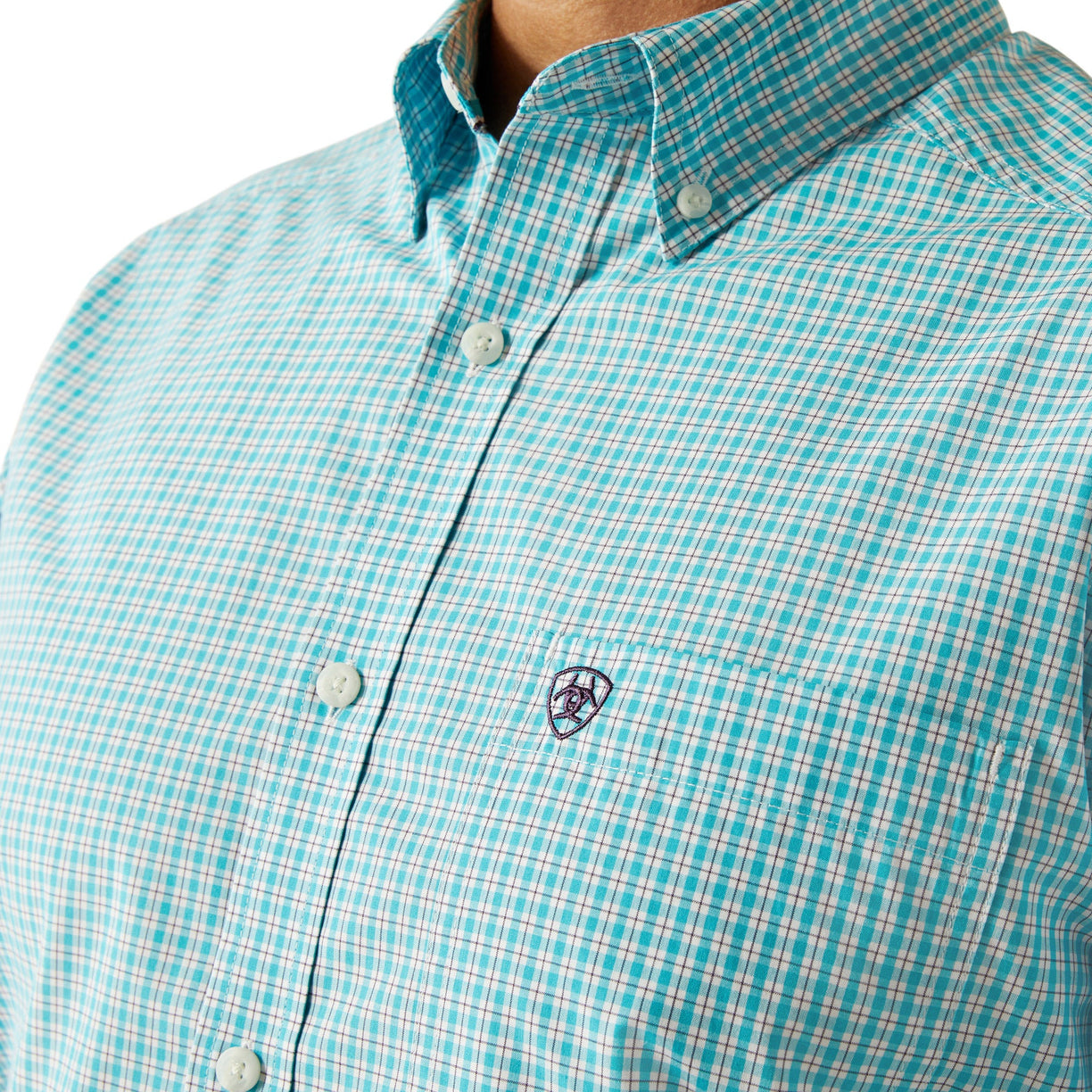 Close-up of a turquoise checkered shirt with a brand logo on a white background