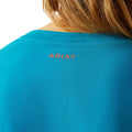 Woman wearing a blue t-shirt with 'COWGIRL' text on a white background
