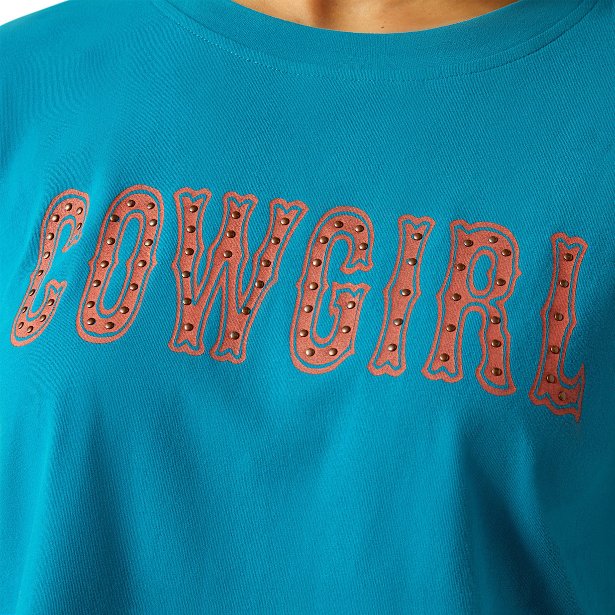 Woman wearing a blue t-shirt with 'COWGIRL' text on a white background