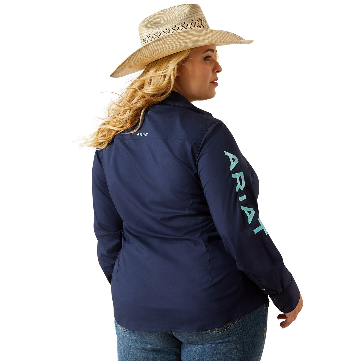 Person wearing a navy Ariat jacket with branding on a white background