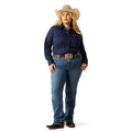 Woman wearing a navy blue shirt, jeans, and a cowboy hat on a white background