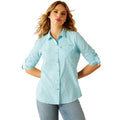 Woman wearing a light blue checkered shirt with a visible brand logo on a white background