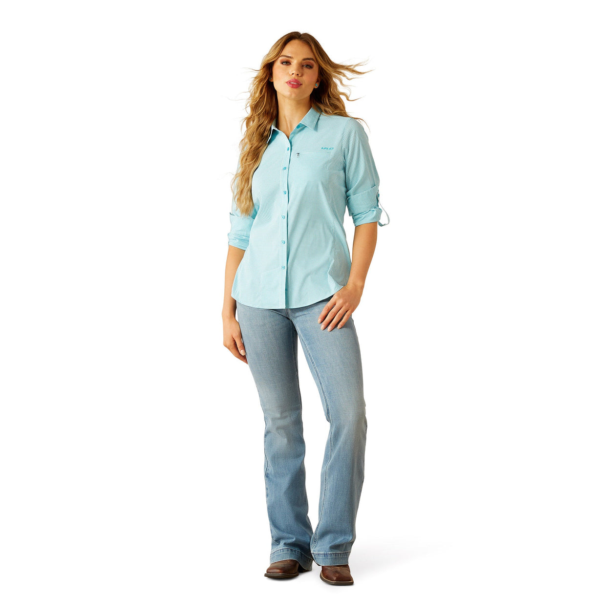 Woman wearing a light blue shirt and jeans on a white background