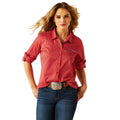 Woman wearing a red striped shirt and blue jeans on a white background