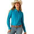 Woman wearing a turquoise shirt, jeans, and a cowboy hat on a white background