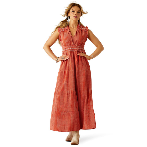 Woman wearing a long orange dress on a white background