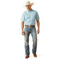 Man wearing a light blue checkered shirt, jeans, and a cowboy hat on a white background