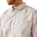 Close-up of a man wearing a plaid shirt with a brand logo on a white background