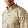 Man wearing a beige patterned shirt with 'Ariat' branding on the collar.