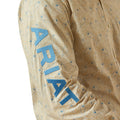 Close-up of a patterned shirt with 'Ariat' branding on a beige background