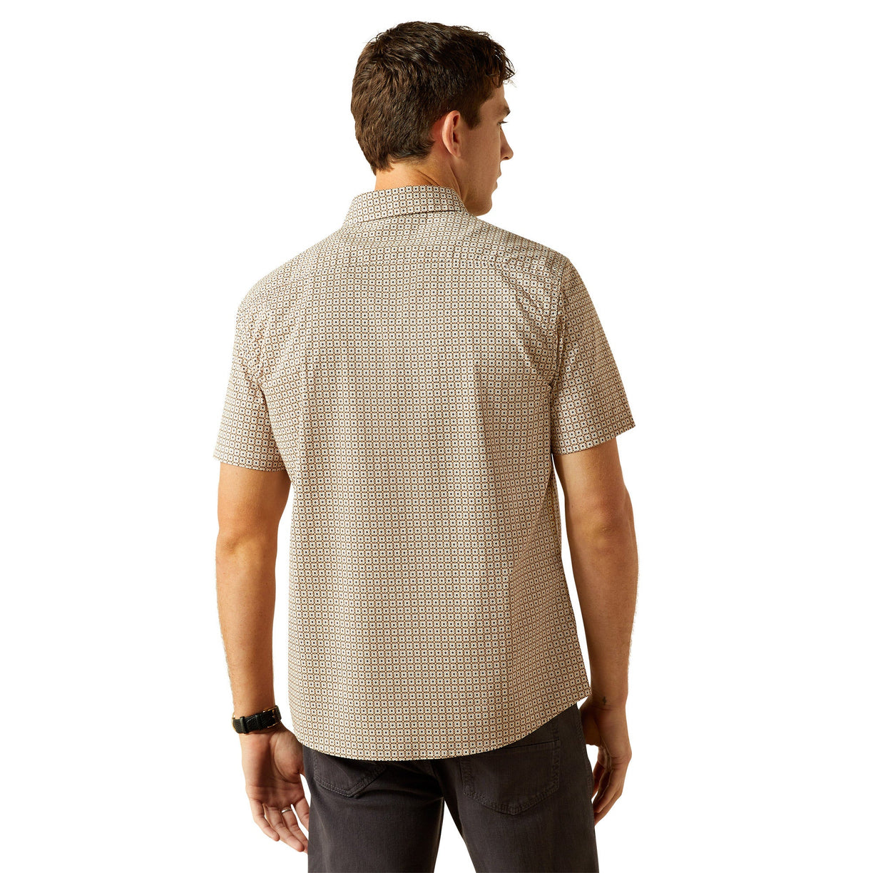 Man wearing a patterned beige shirt on a white background