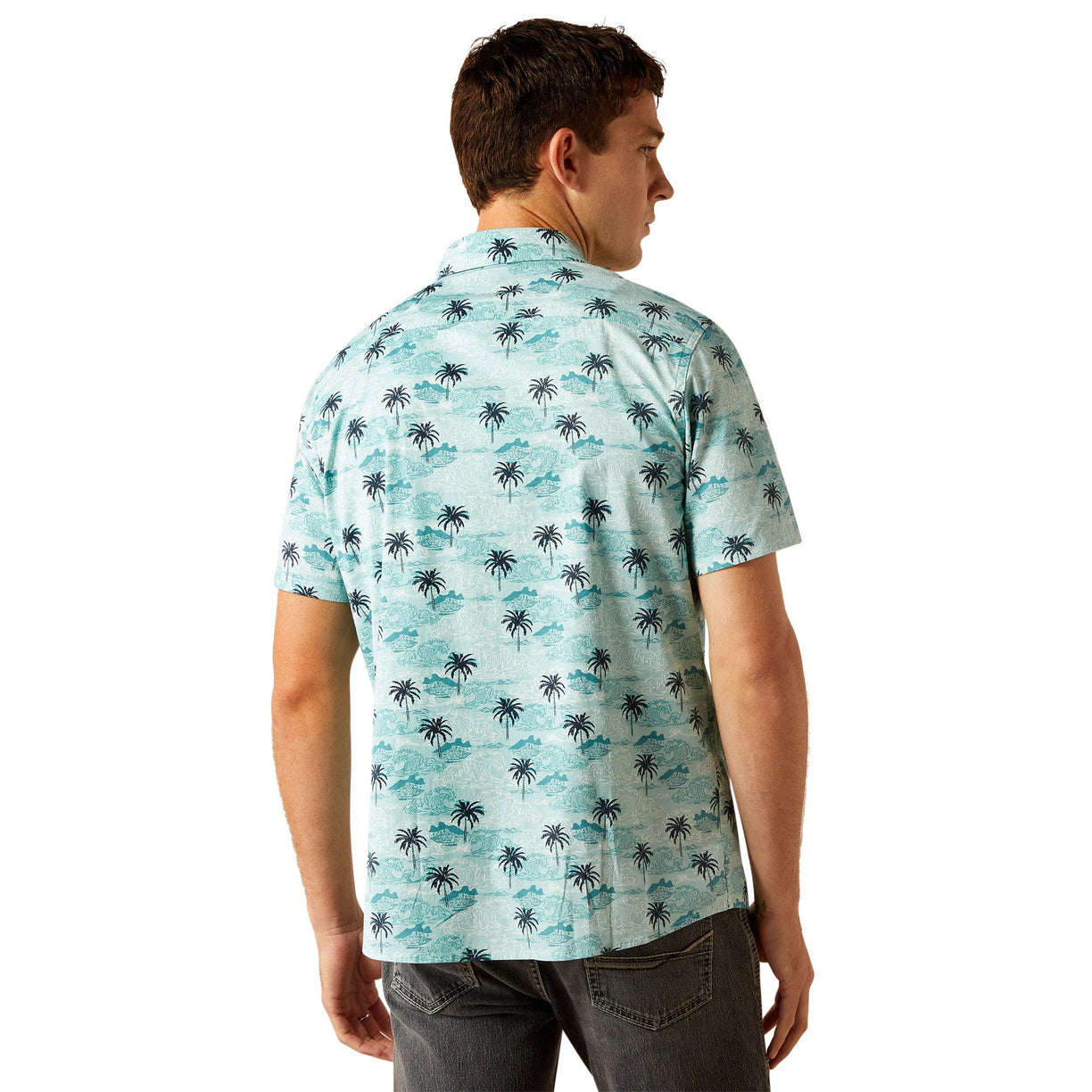 Man wearing a light blue shirt with palm tree pattern on a white background