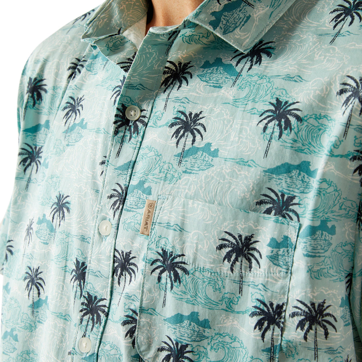 Close-up of a light blue shirt with palm tree pattern