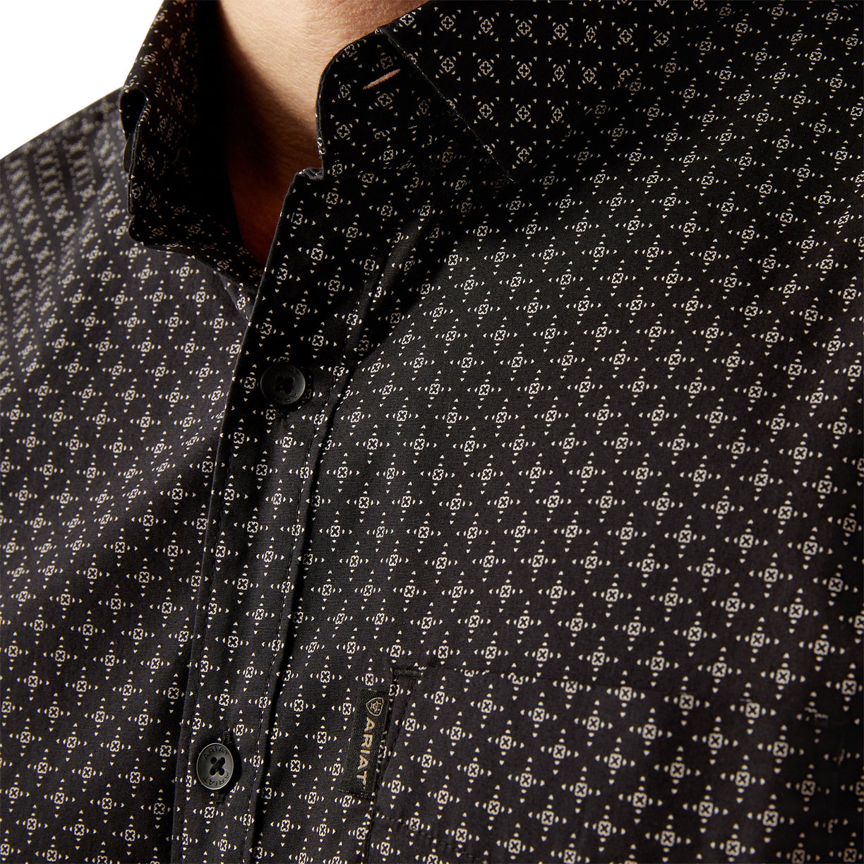 Close-up of a black patterned shirt with buttons