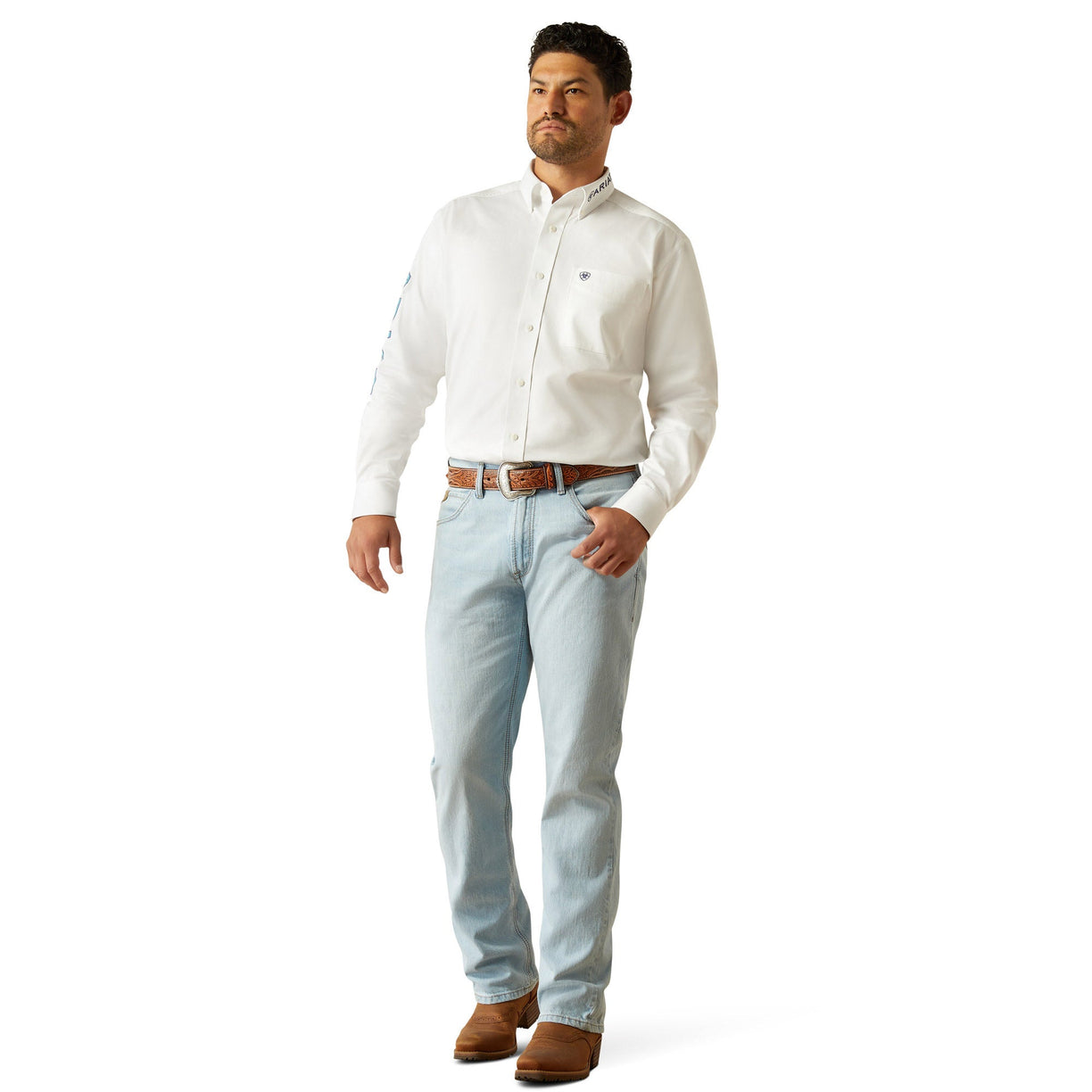 Man wearing a white dress shirt and light blue jeans on a white background