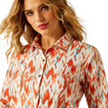 Woman wearing a colorful patterned shirt on a white background