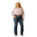 Woman wearing a pink patterned shirt, blue jeans, and a cowboy hat on a white background