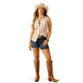 Woman wearing a sleeveless striped shirt and denim with a cowboy hat on a white background