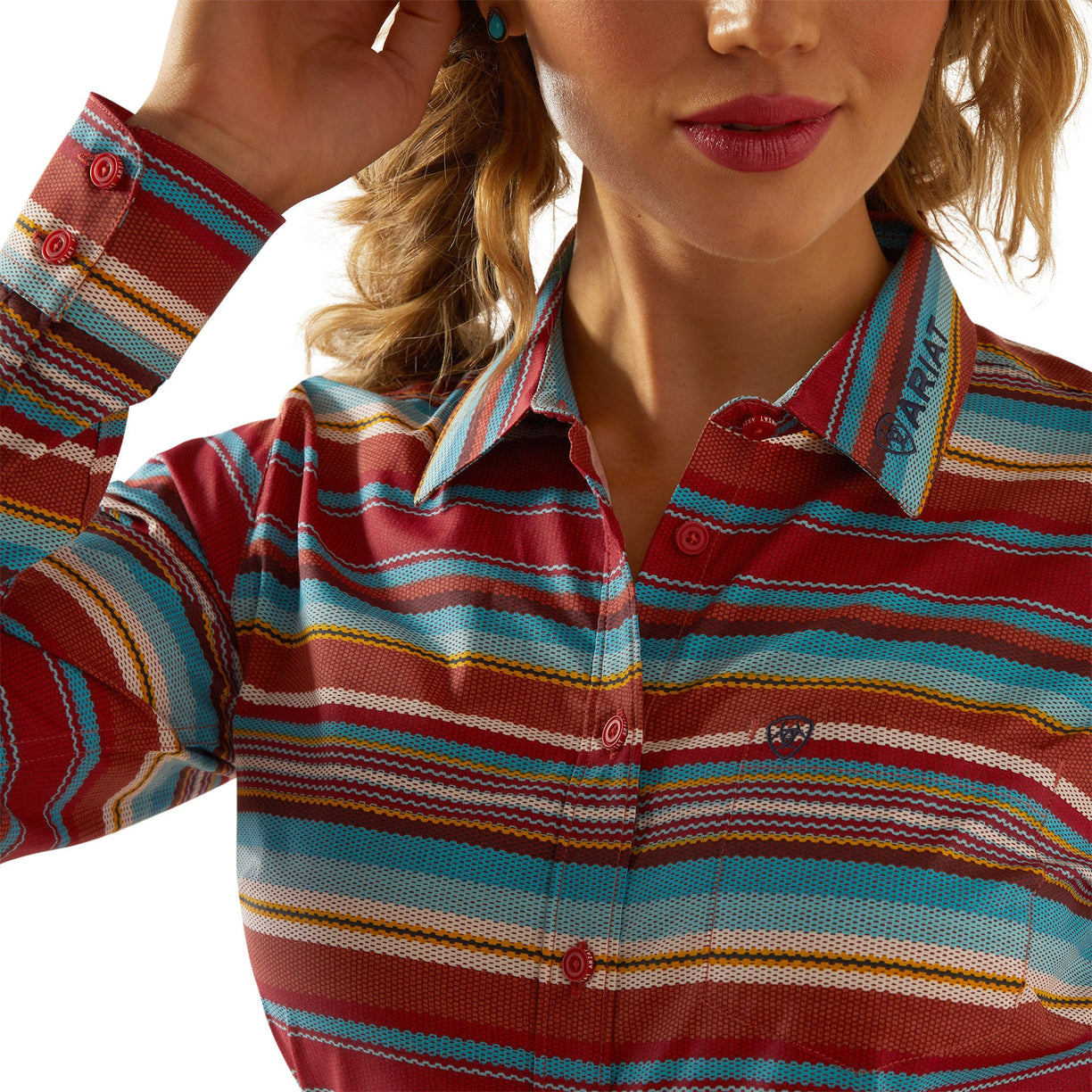 Close-up of a person wearing a colorful striped shirt with a brand logo.