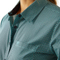 Close-up of a person wearing a patterned shirt with a geometric design.