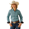 Woman wearing a teal patterned shirt, blue jeans, and a cowboy hat on a white background