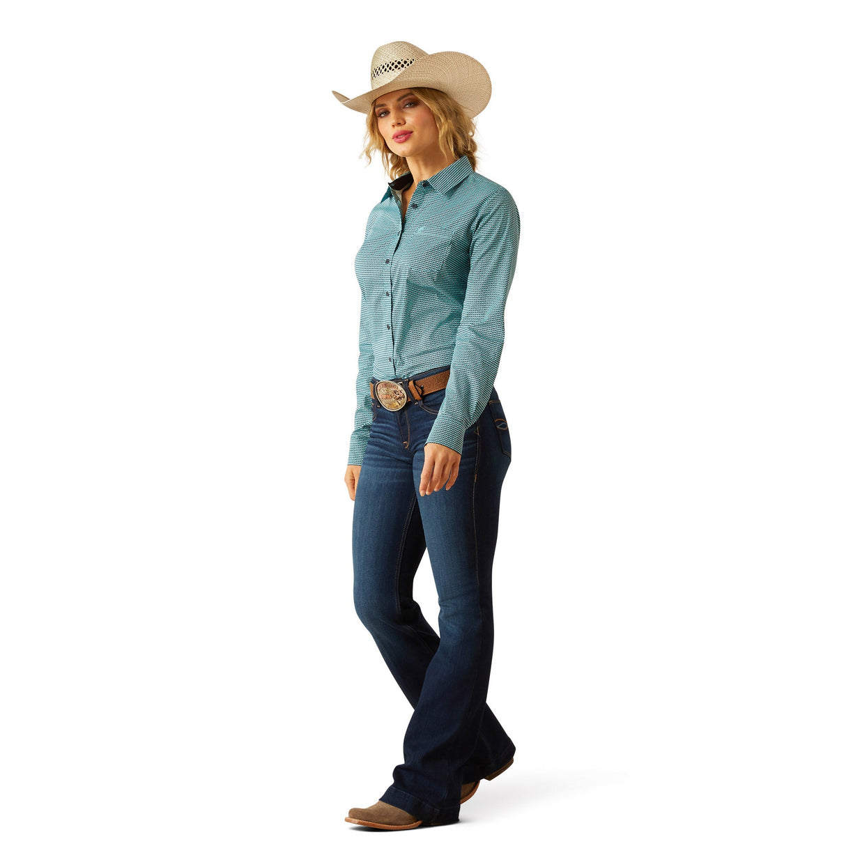 Woman wearing a light blue shirt, dark blue jeans, and a beige cowboy hat on a white background