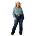 Woman wearing a light blue shirt, dark blue jeans, and a cowboy hat on a white background