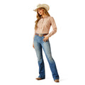 Woman wearing a cowboy hat, striped shirt, and blue jeans on a white background