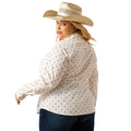 Woman wearing a white blouse with red patterns and a cowboy hat on a white background