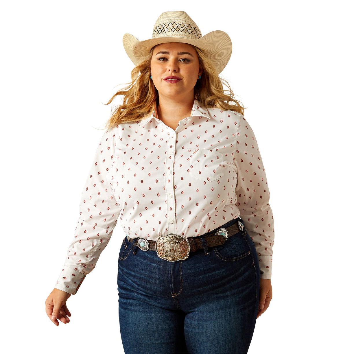 Woman wearing a white blouse with red patterns, blue jeans, and a straw cowboy hat on a white background
