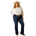 Woman wearing a white patterned shirt, blue jeans, and a cowboy hat on a white background