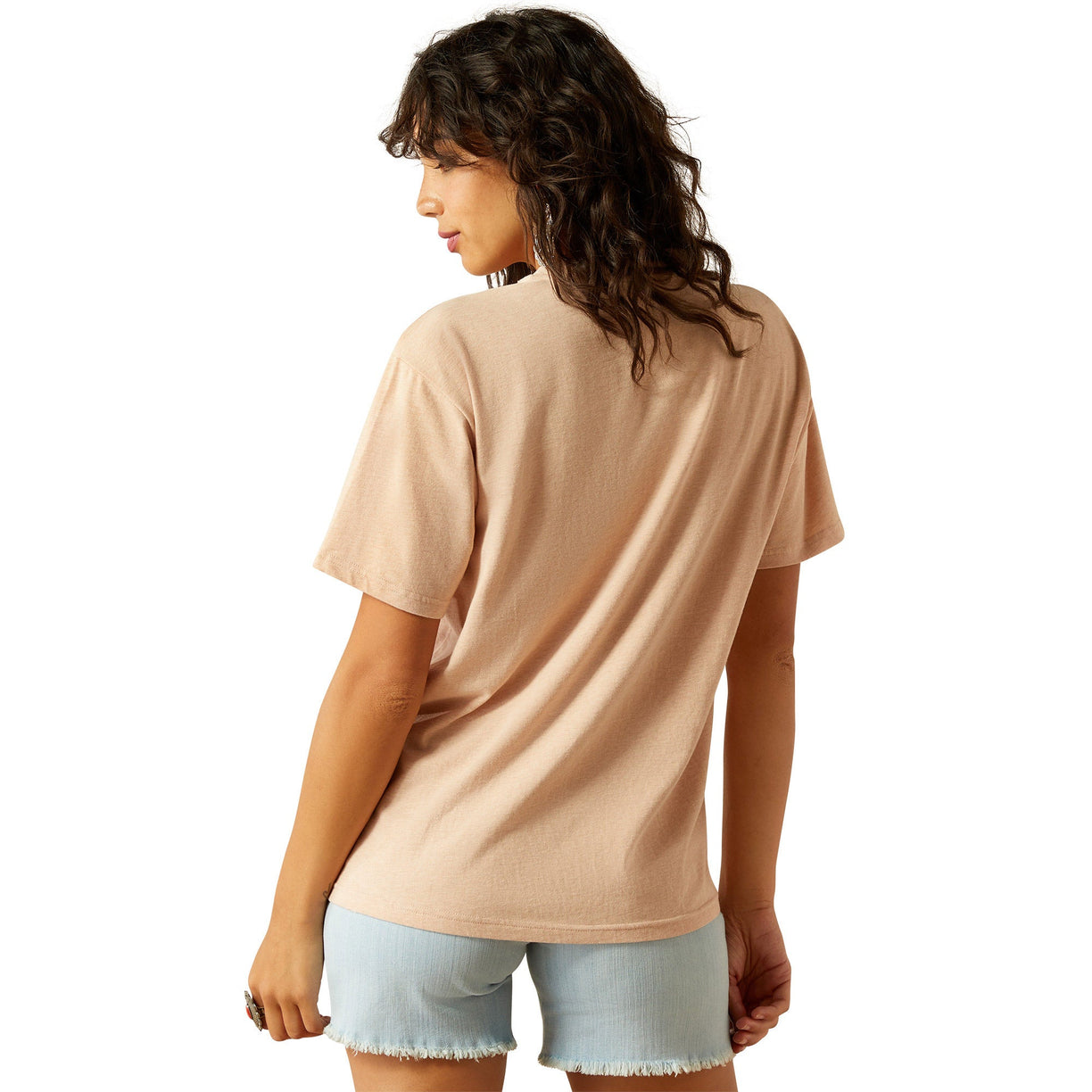 Woman wearing a beige t-shirt and light blue shorts on a white background