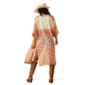 Woman wearing a floral dress and cowboy hat on a white background