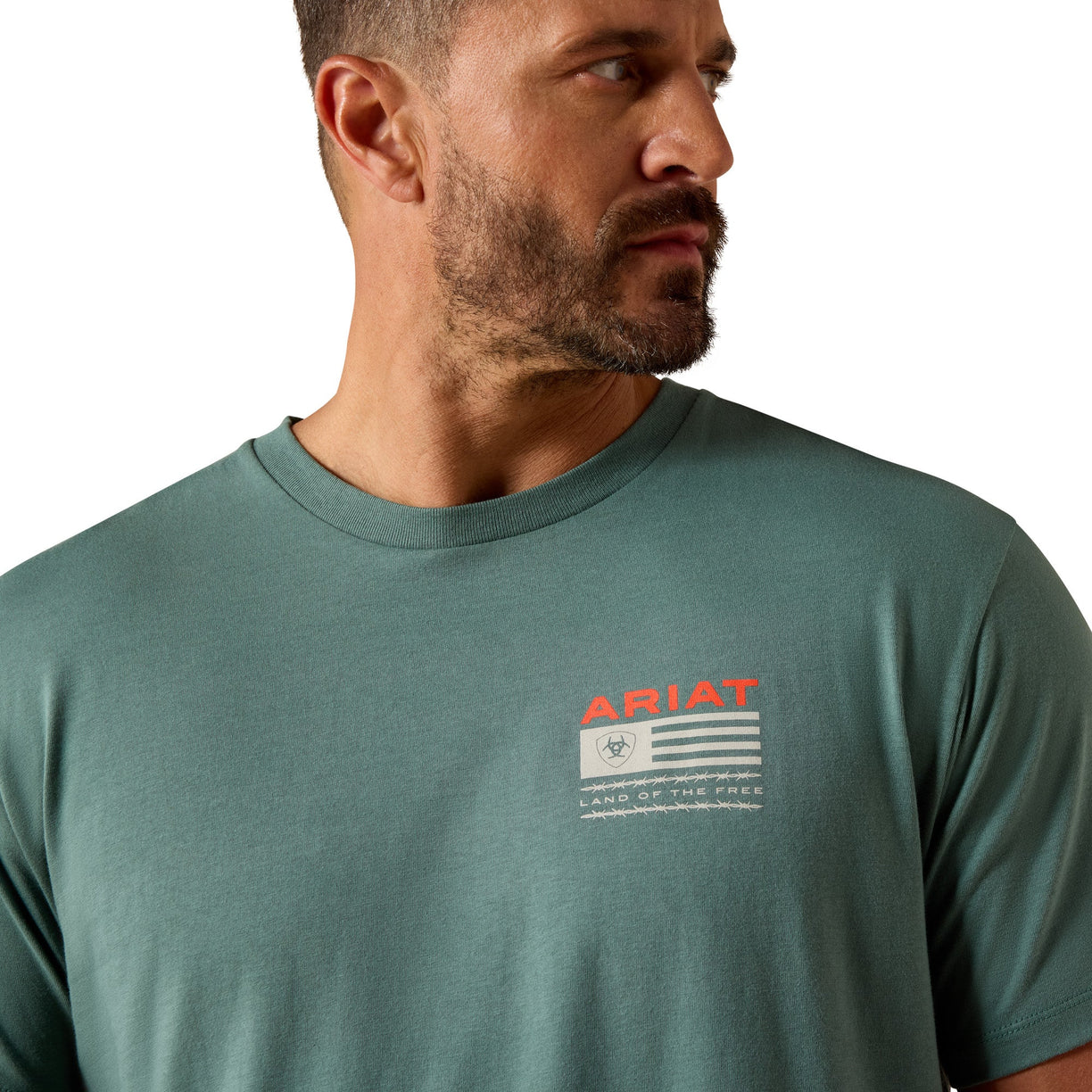 Man wearing a green Ariat t-shirt with a logo on a white background