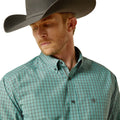 Man wearing a green plaid shirt and gray cowboy hat on a white background