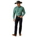 Man wearing a green checkered shirt, black cowboy hat, and dark jeans on a white background