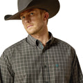 Man wearing a plaid shirt and cowboy hat on a white background