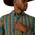 Man wearing a plaid shirt with a neutral background