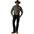 Man wearing a plaid shirt, jeans, and cowboy hat on a white background