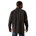 Man wearing a black patterned shirt on a white background