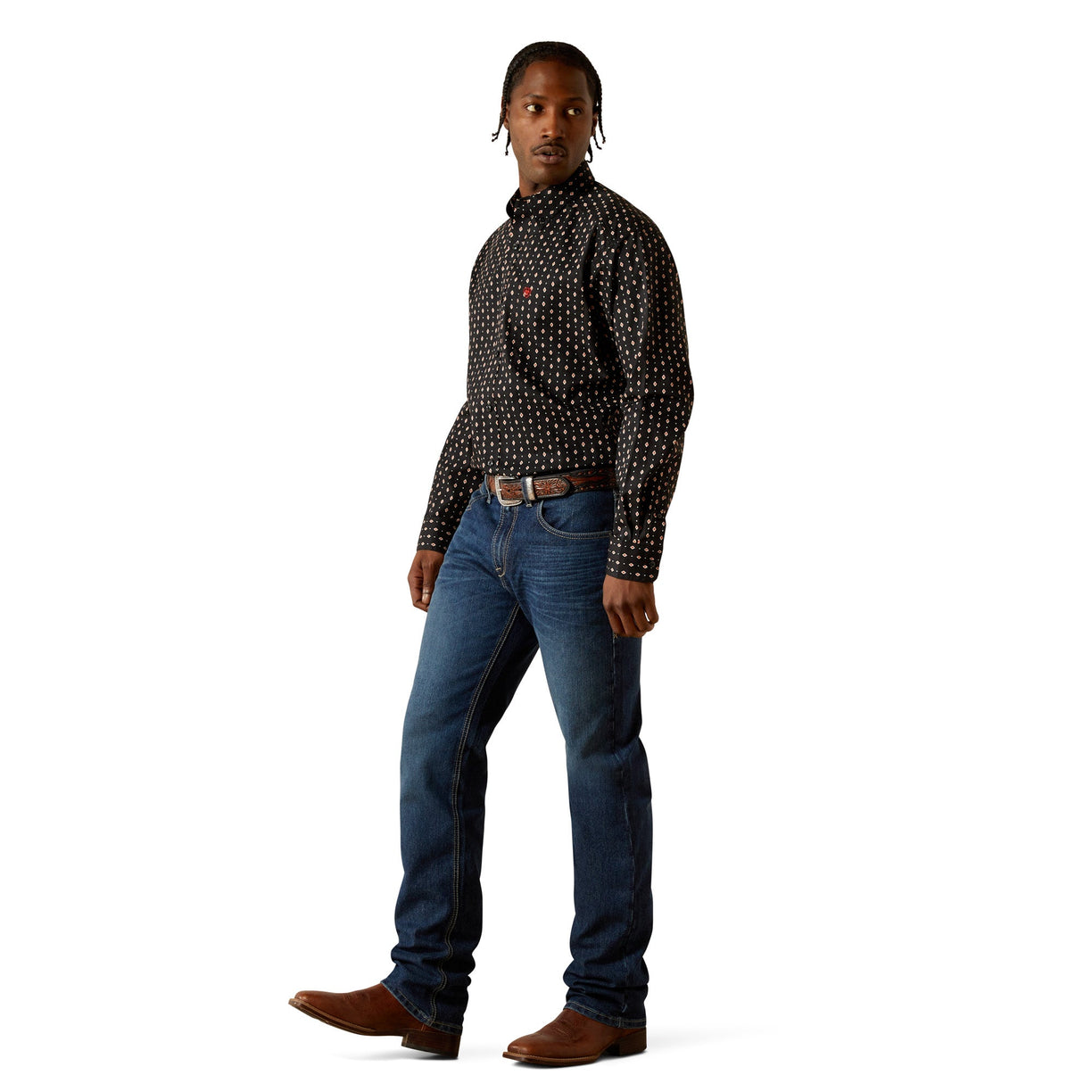 Man wearing a patterned shirt and jeans on a white background