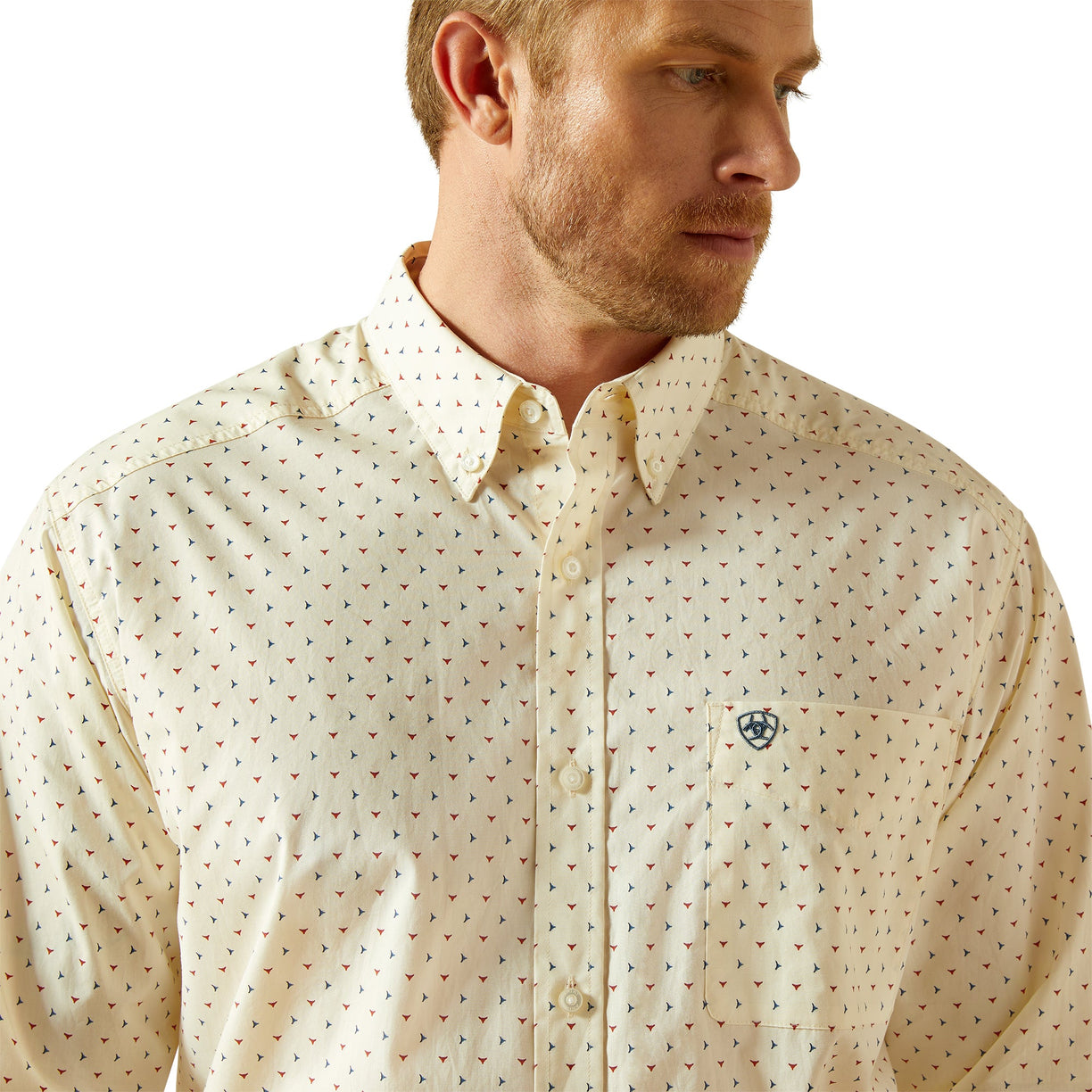 Man wearing a cream-colored patterned shirt on a white background