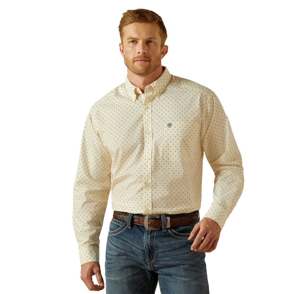 Man wearing a cream patterned shirt and blue jeans on a white background