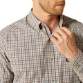 Man wearing a plaid shirt with a close-up of the collar and buttons.