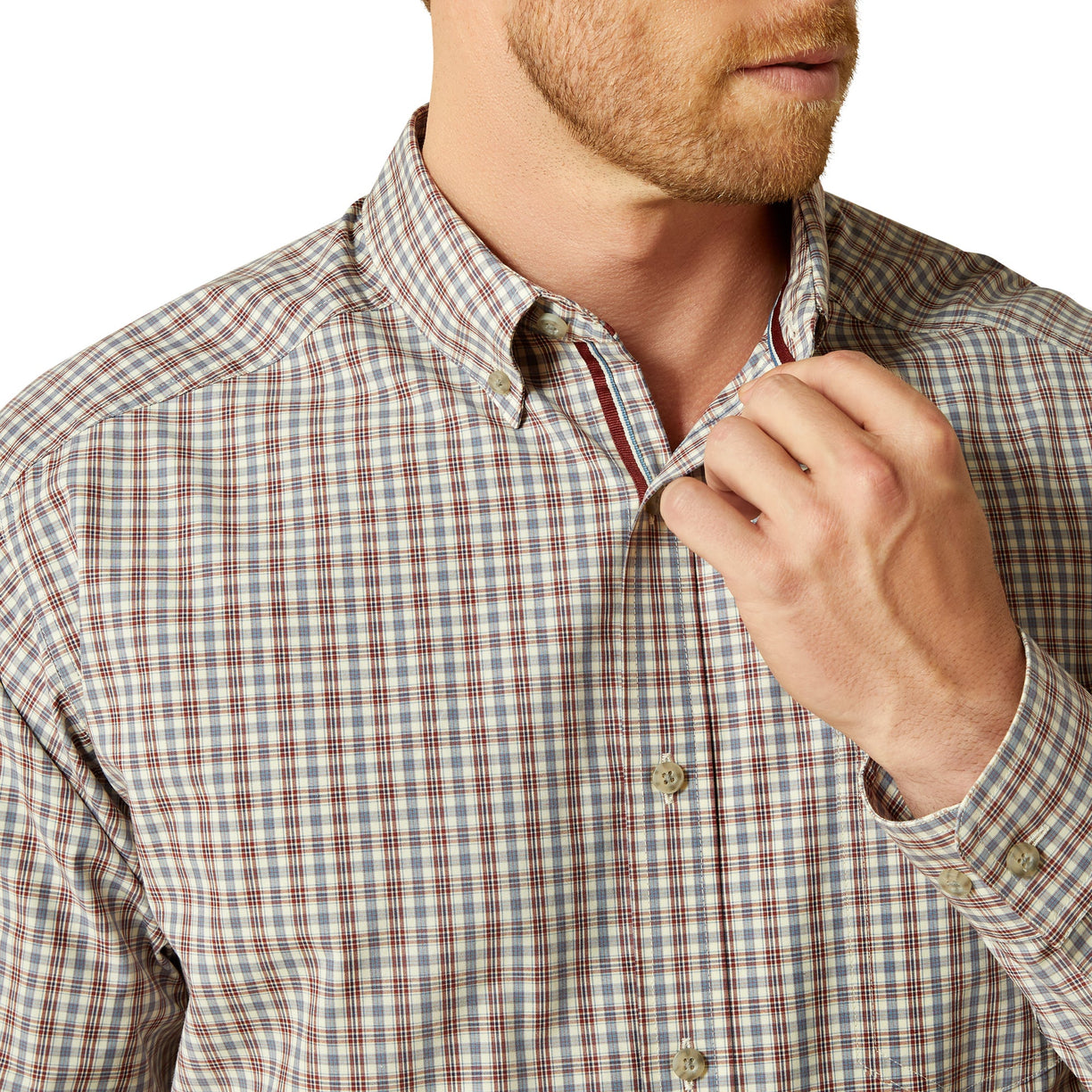 Man wearing a plaid shirt with a close-up of the collar and buttons.